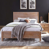 A cozy bedroom featuring a wooden bed flanked by matching nightstands, creating a warm and inviting atmosphere.